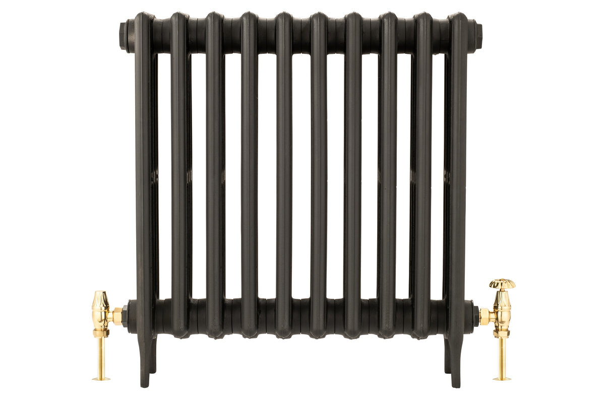 Florence Manual Radiator Valve Set in brass, fitted to black radiator