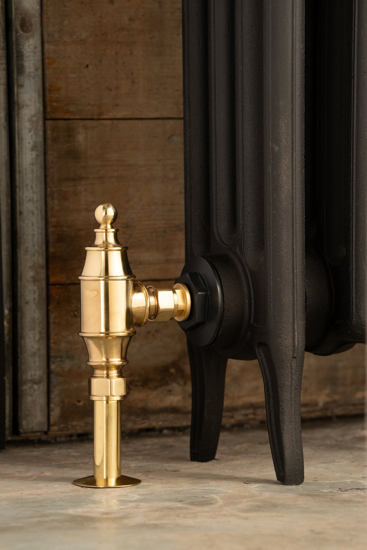 Valora Thermostatic Radiator Valve Set lockshield in brass, on black radiator